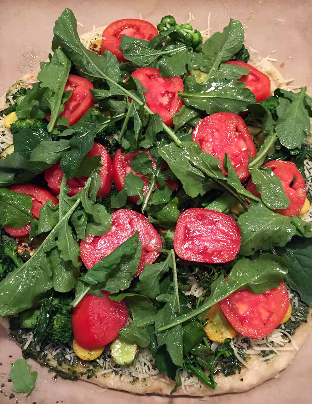 Next, I added the sliced Howard German tomatoes (so meaty and sweet!) and the arugula. I spritzed it all with a light spray of olive oil and put it in a 350 degree oven.