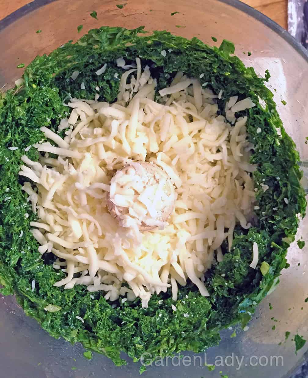 I put some cheese in the food processor to blend with the pesto before putting it on the pizza crust.